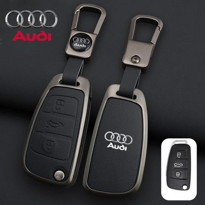 Audi key fob and remote control on a dark background with Audi logo.