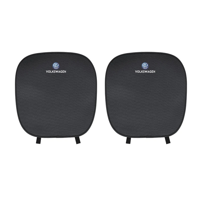 Two black car seat covers with Volkswagen logo on a white background