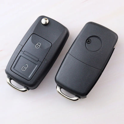 Two black car key fobs on a white background