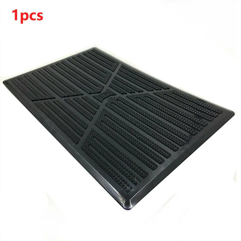 Black rubber mat with textured surface on a white background
