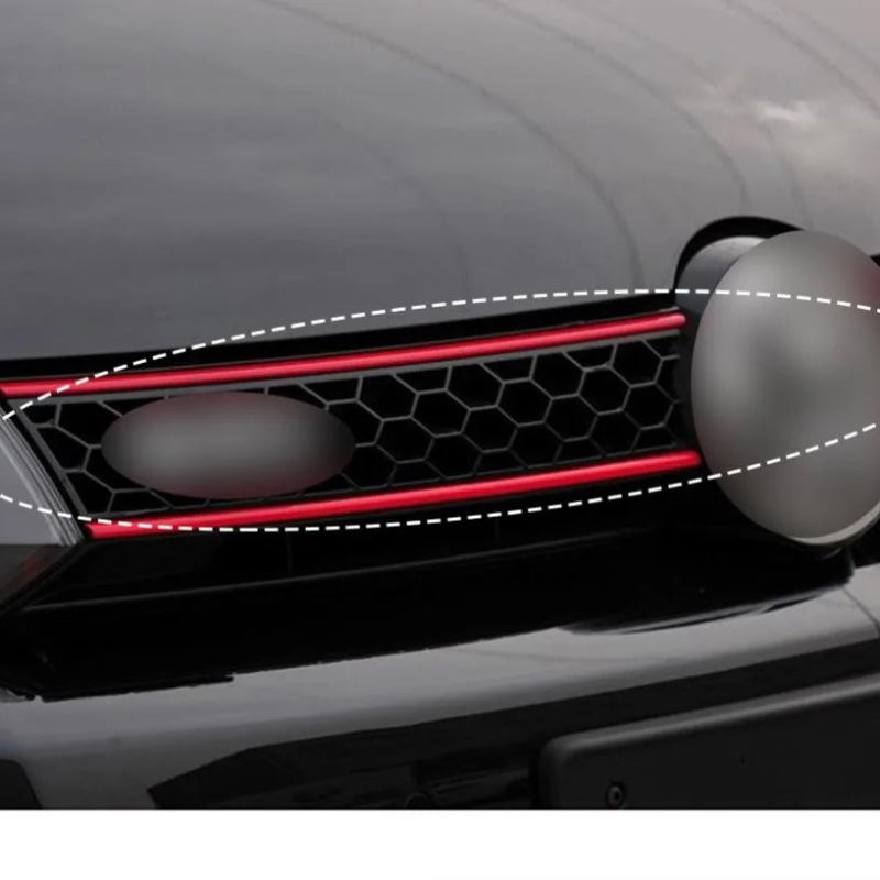Car grille with red accent and honeycomb pattern on a dark background