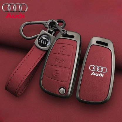 Audi key fob with red leather strap on a red background