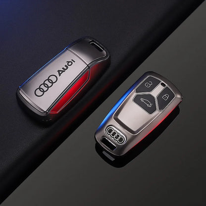 Two Audi car key fobs on a dark background