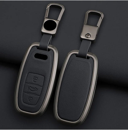 Two car key fobs with metallic casings on a dark background