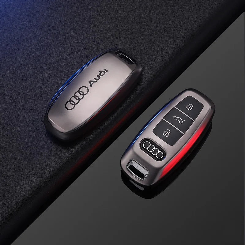Audi key fob and remote control on a dark surface