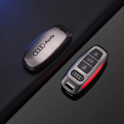 Audi key fob and remote control on a dark surface
