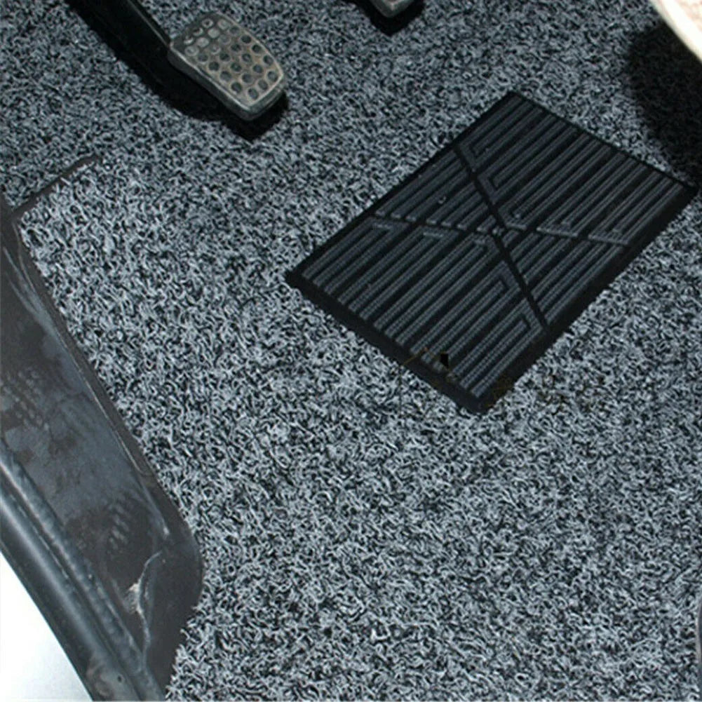 Close-up of a textured gray floor mat with a black rectangular mat on top