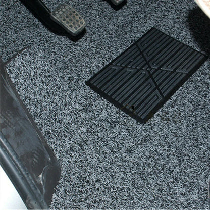 Close-up of a textured gray floor mat with a black rectangular mat on top