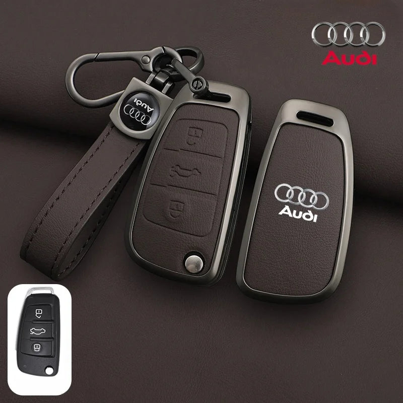 Audi car key fob with leather strap on a brown background, featuring the Audi logo.