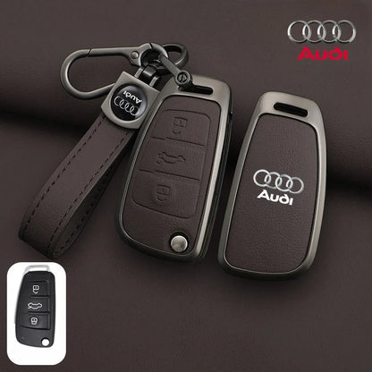 Audi car key fob with leather strap on a brown background, featuring the Audi logo.