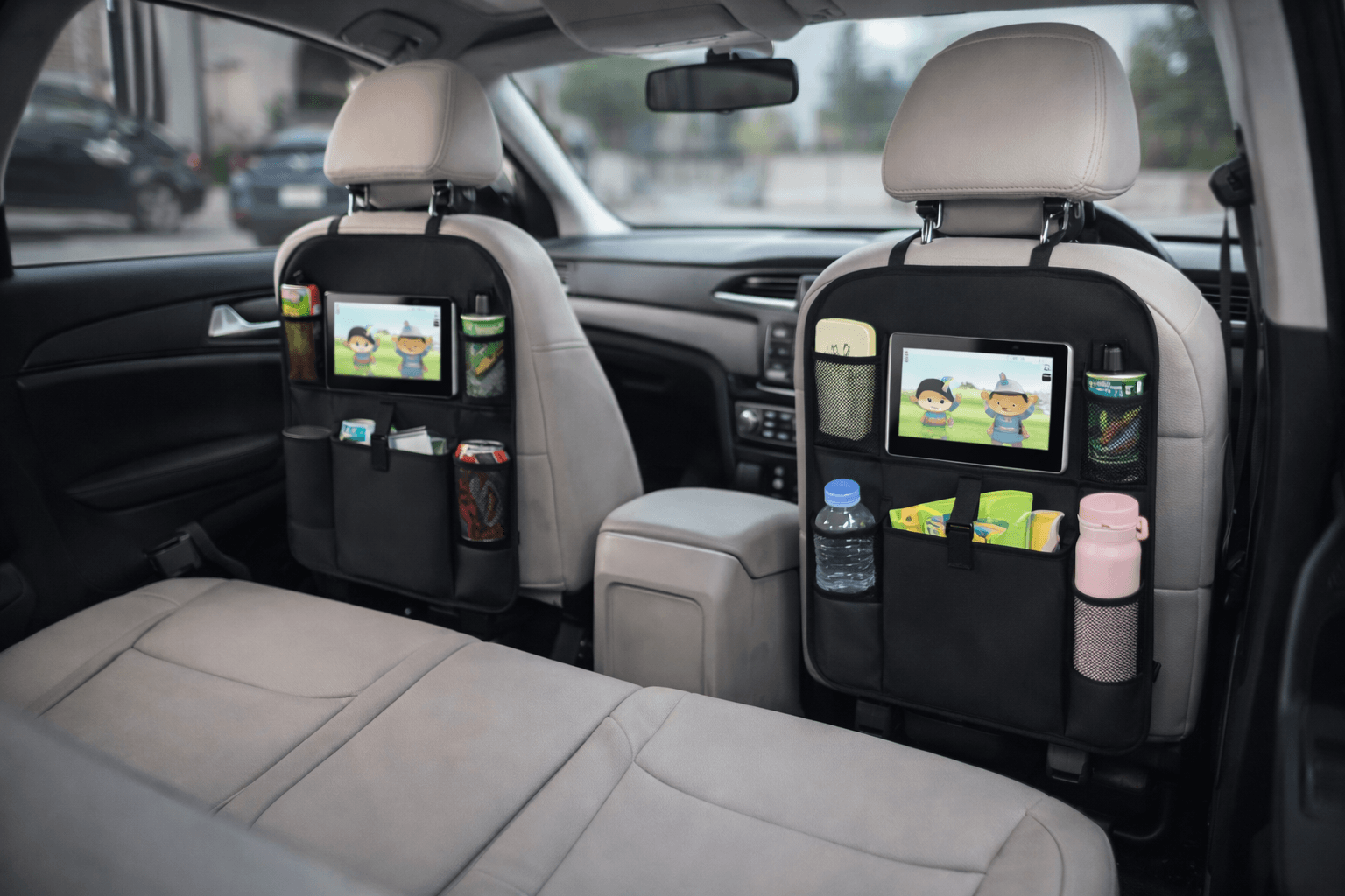 Car backseat organisers on the front seats holding tablets, drinks bottles and snacks