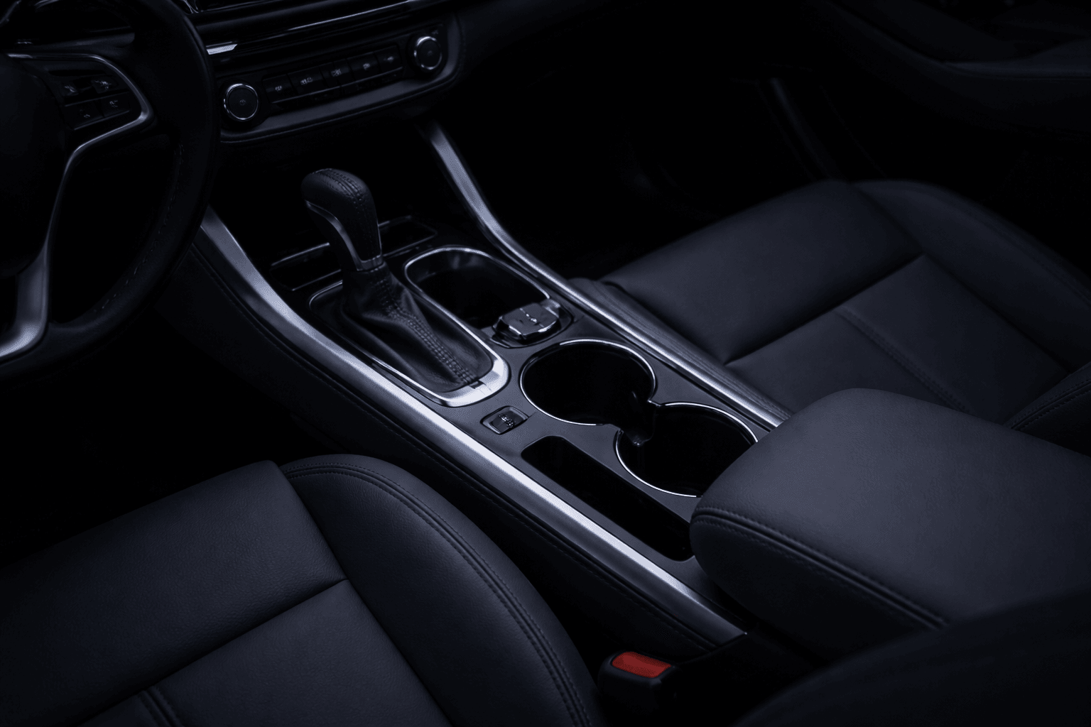 Dark car centre console at night with unlit cup holders, before fitting LED cup holder lights