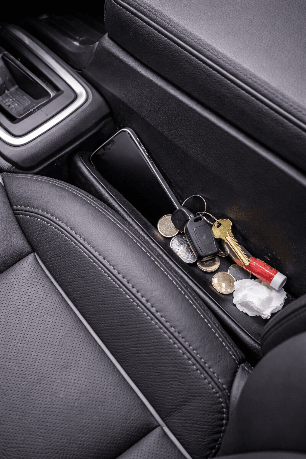 Keys, coins and small items fallen into the gap between a car seat and centre console